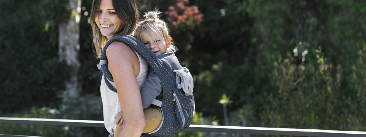 Mom carrying baby in an Ergobaby Original Baby Carrier